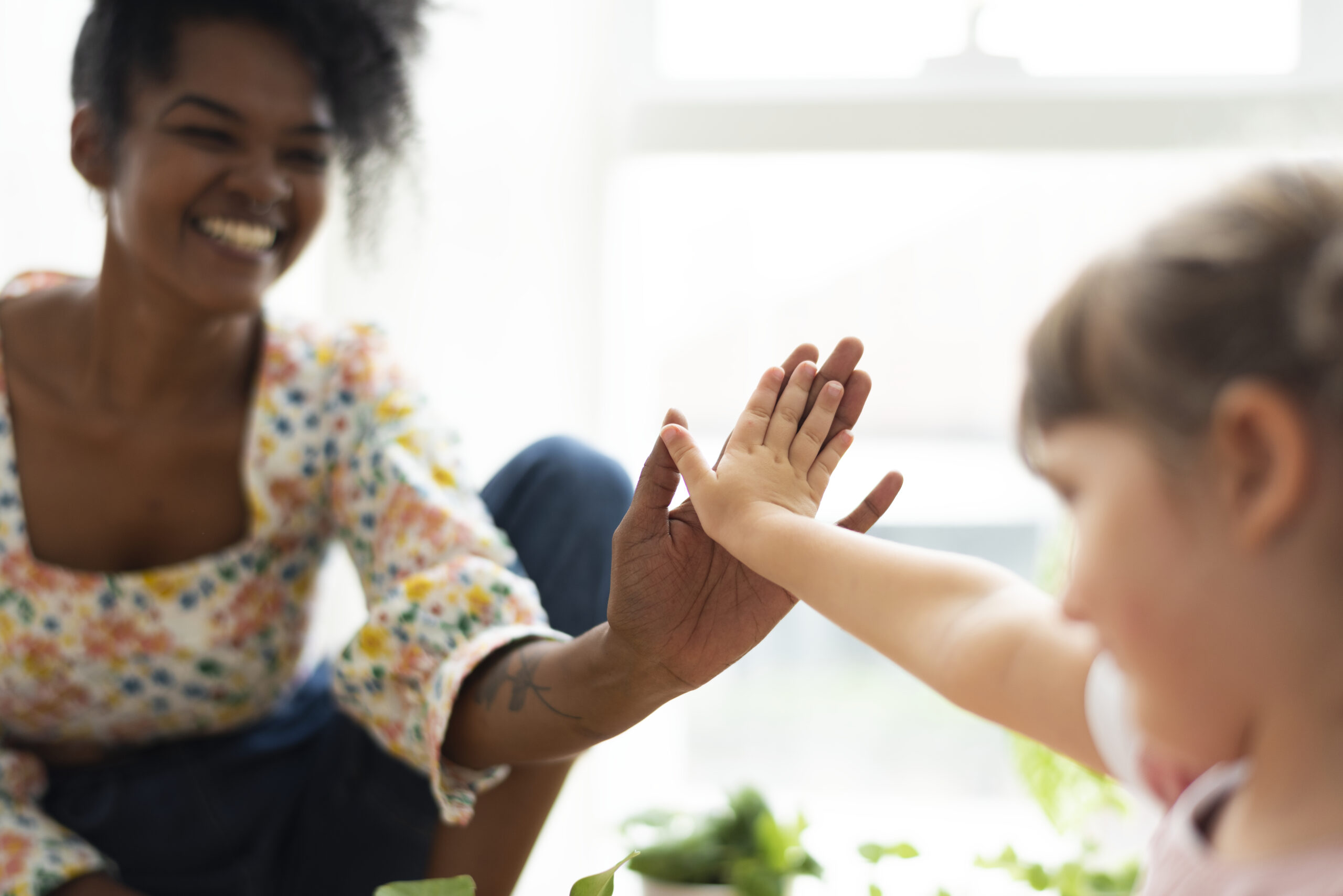 Multiracial family at home doing a high five